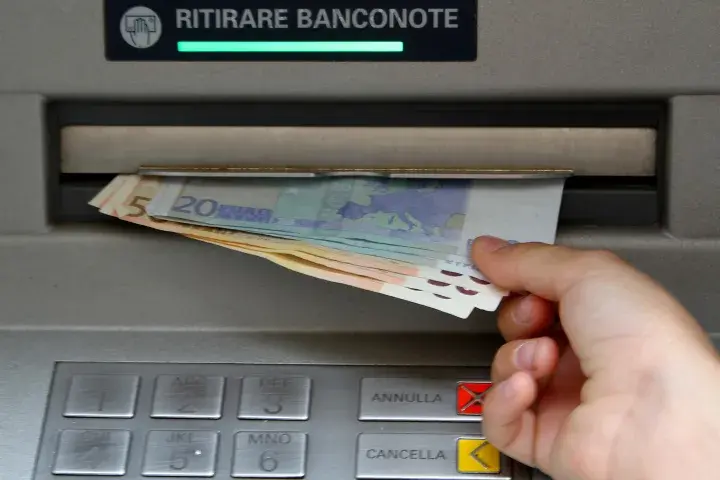 Person pulling money out of an ATM