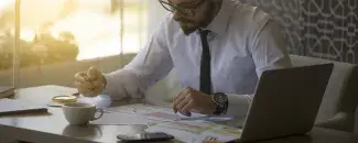 Man reviewing charts and tables